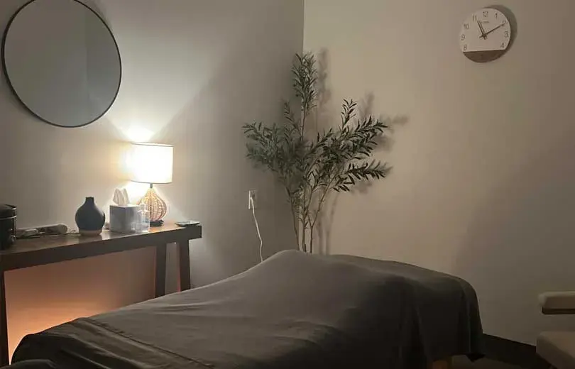 A softly lit massage treatment room at Harmony Massage and Wellness
