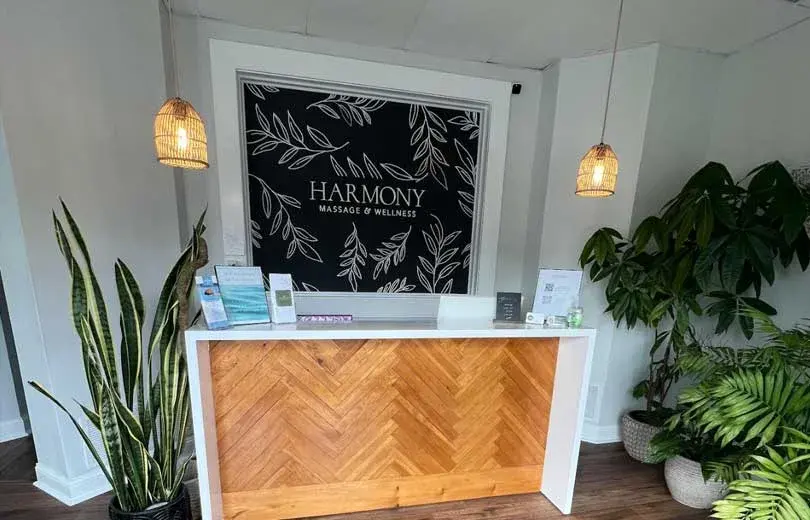 The plant-filled reception desk at Harmony Massage and Wellness